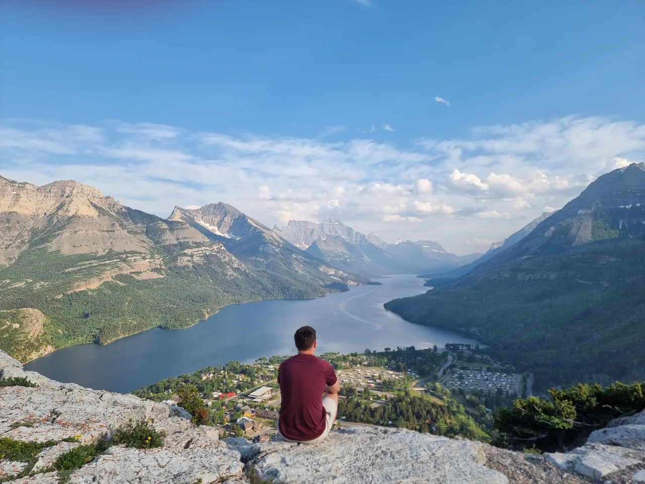 Taking in the view of a mountain-lined lake from a rocky lookout.